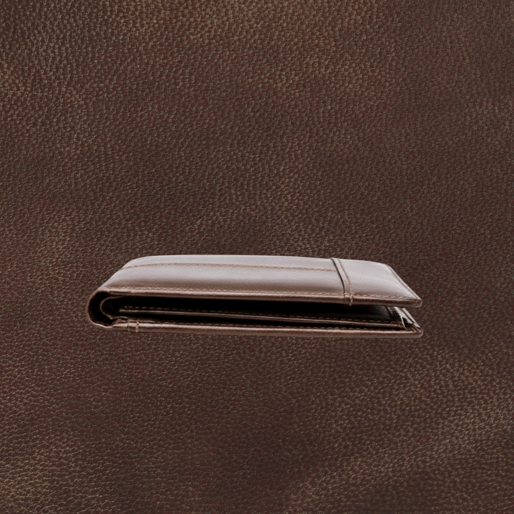 Brown leather wallet on a matching brown background