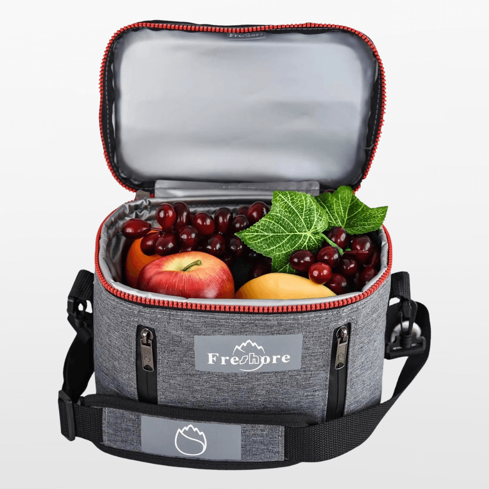 Gray cooler bag with fresh fruits and vegetables on a light gray background