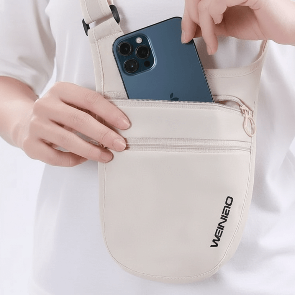 Person placing a phone into a beige sling bag with 'WEINIE' branding.