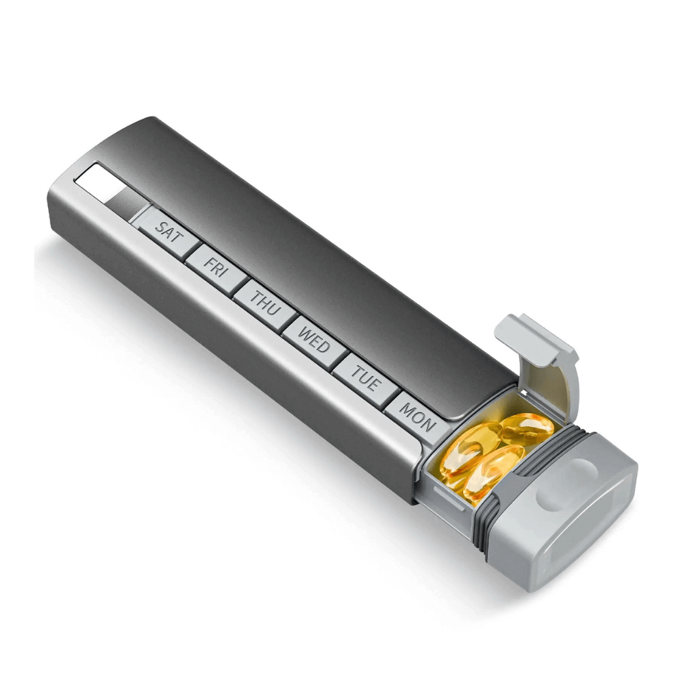 Silver pill organizer with compartments labeled for each day of the week, containing yellow pills.