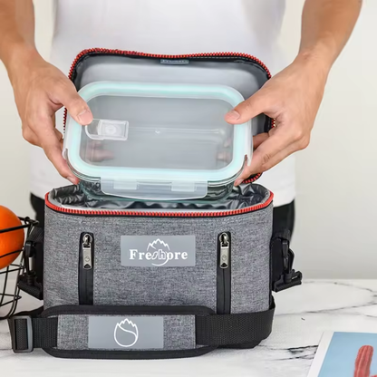 Person opening a gray cooler bag with a red interior, featuring the Freshpre brand.