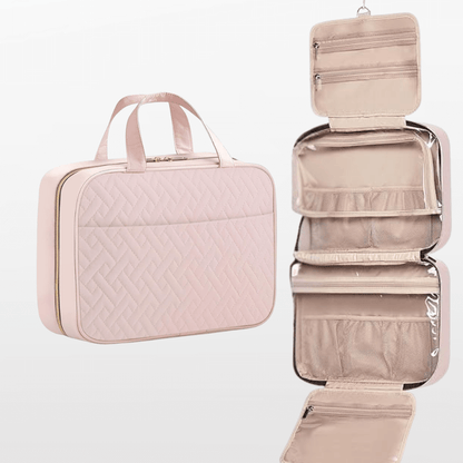 Pink travel organizer with a quilted design and a hanging compartment on a white background