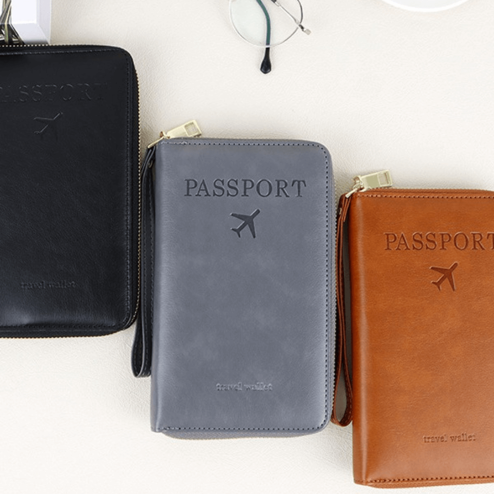 Three passport holders in black, gray, and brown on a white background
