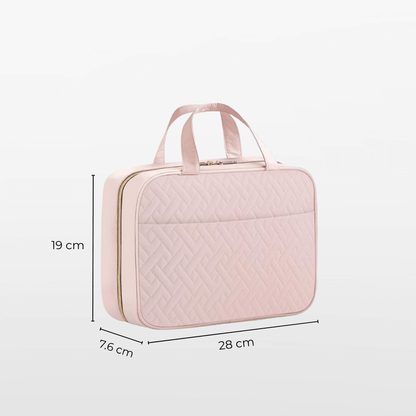 Pink quilted travel bag with dimensions on a white background