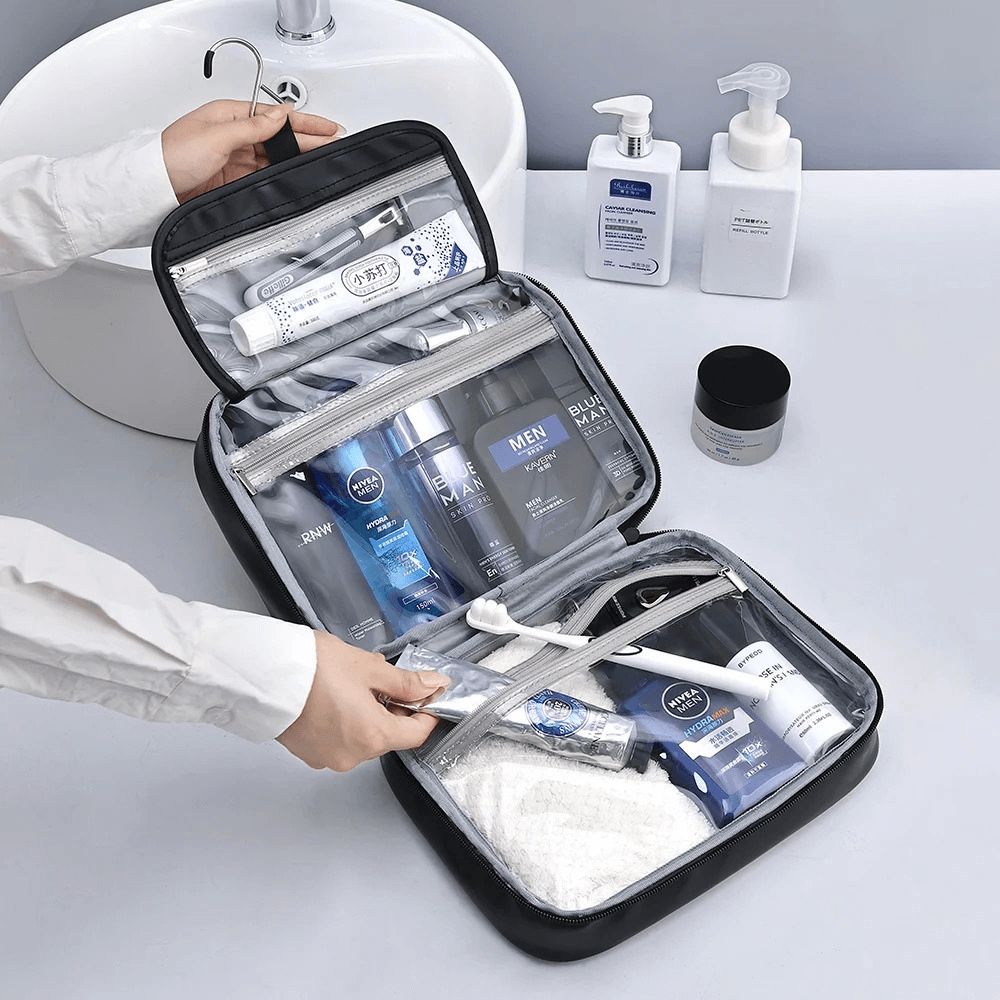 Open travel toiletry bag with various products on a bathroom counter