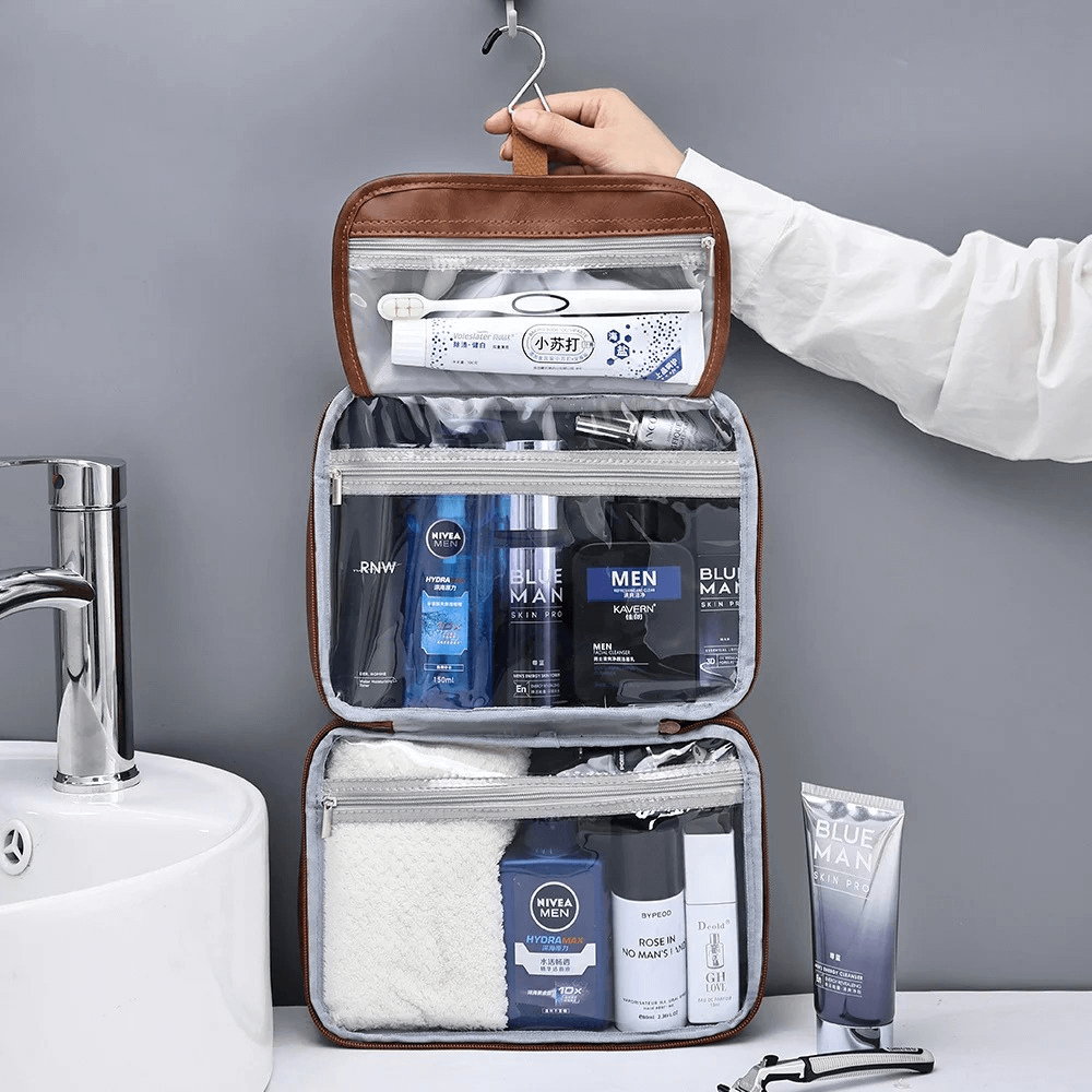 Toiletry bag with grooming products on a gray background