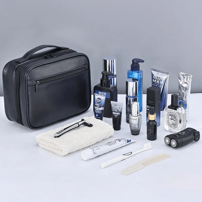 Grooming products including a black travel case, bottles, and personal care items on a light gray background.