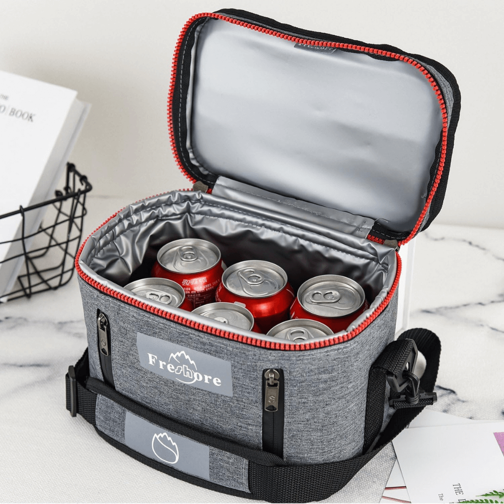 Gray cooler bag with red trim containing red and silver cans, branded 'Freshpre'.