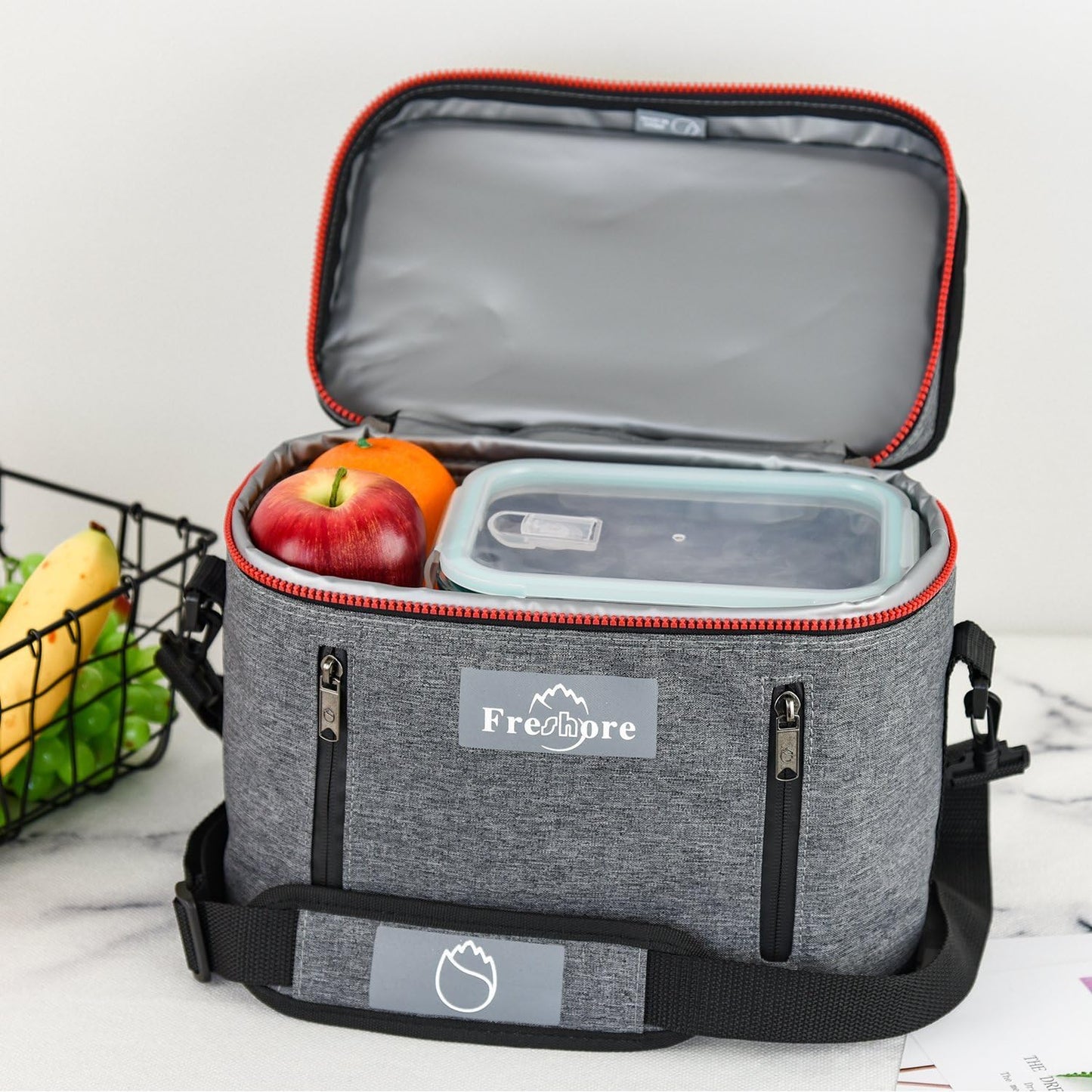 Gray cooler bag with 'Freshpre' branding, open to reveal food items on a white background.