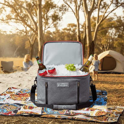 Gray cooler bag with drinks on a picnic blanket in a park setting